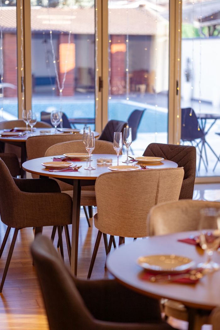 gallery-2 Sophisticated dining setting with an outdoor pool view, ideal for upscale dining experiences.