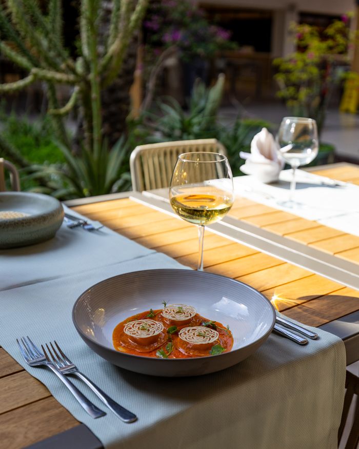 services-02 Gourmet ravioli served in an elegant outdoor setting with a glass of wine, perfect for fine dining experiences.